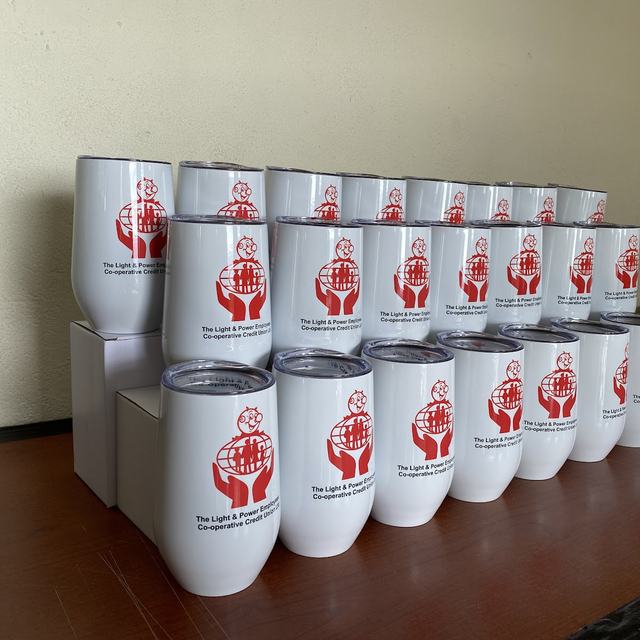 Stacked white tumblers with logo